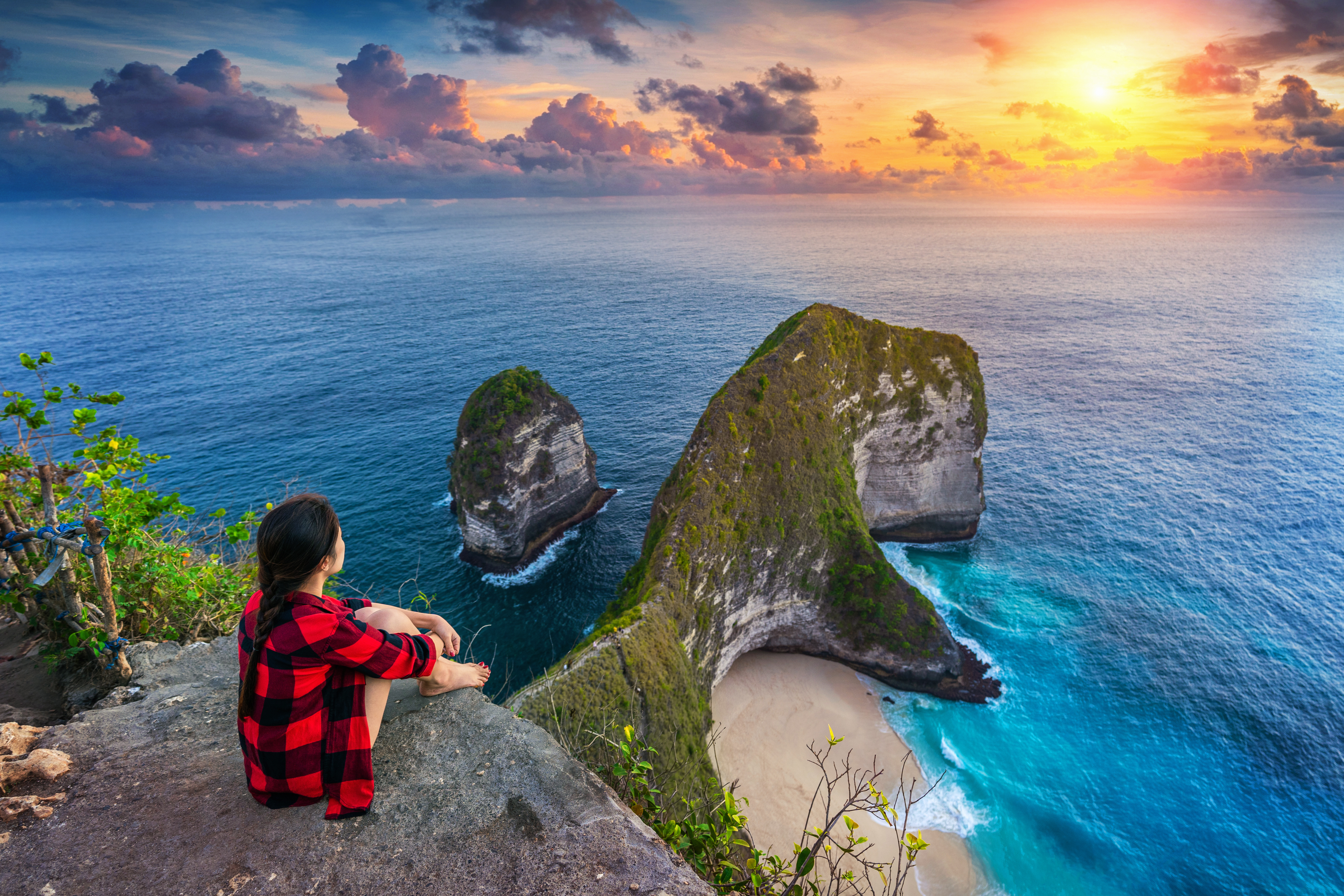 1751274816_947232-woman-sitting-cliff-looking-sunset-kelingking-beach-nusa-penida-island-bali-indonesia.jpg